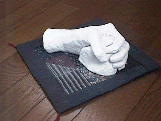 A Hand made of paper-clay